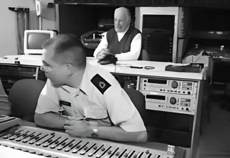 Hank Levy listening to a playback in the recording studio at Fort Meade